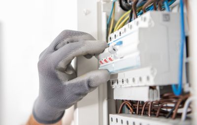 Electrician Working on a Circuit Breaker